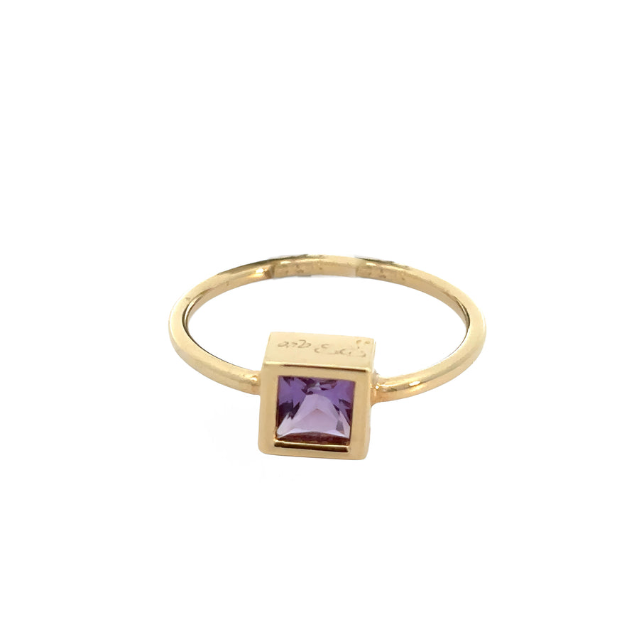 14k gold ring with purple amethyst center stone on white background