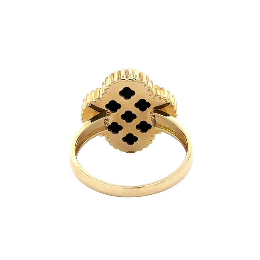 Woman wearing 14k gold ring with black accent, pairing it with other jewelry pieces