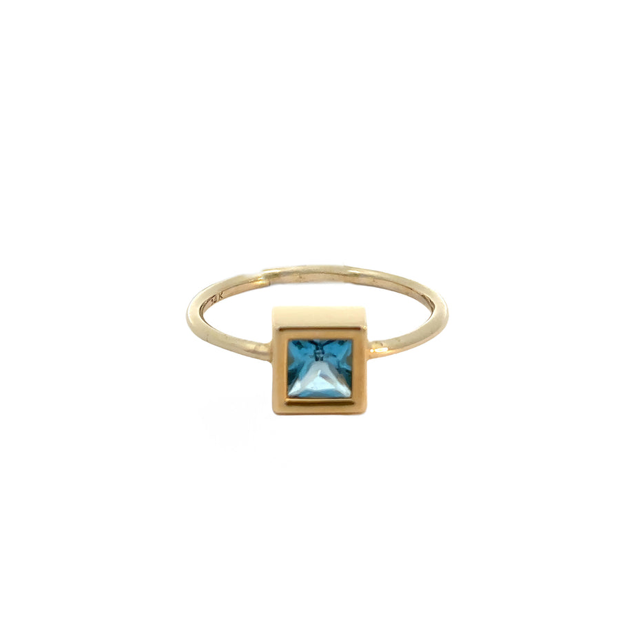 Elegant 14k gold ring featuring vibrant blue center stone