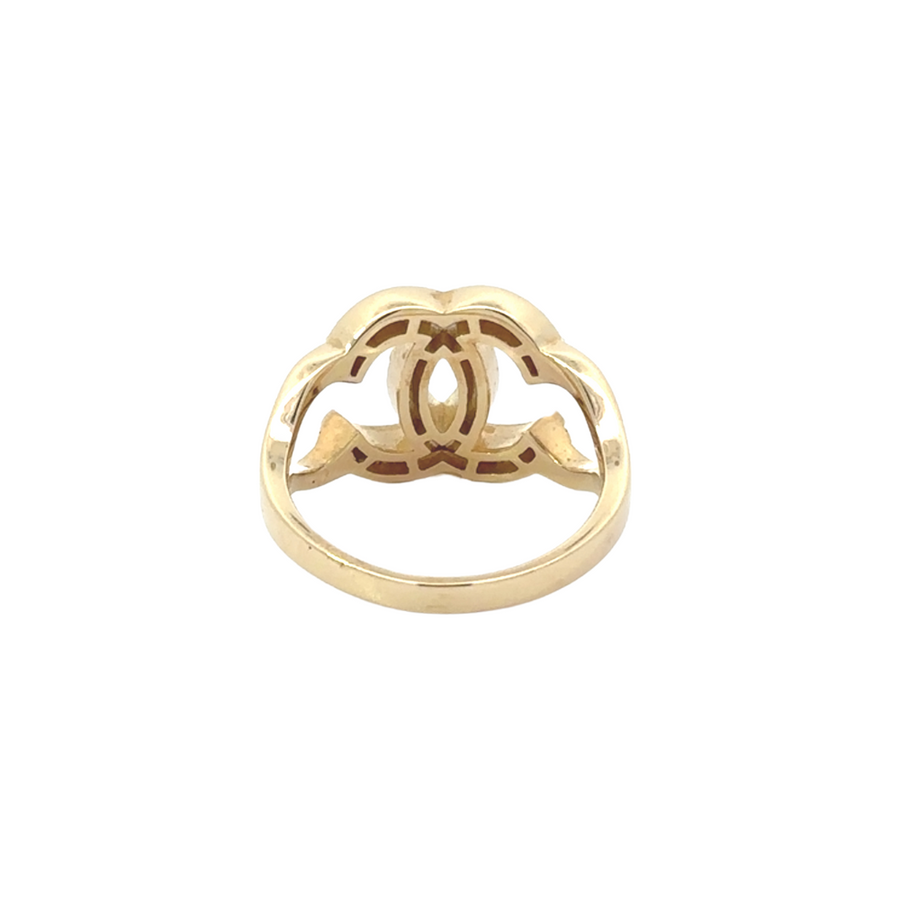 Woman wearing 14k gold ring with cubic zirconia, paired with other gold jewelry