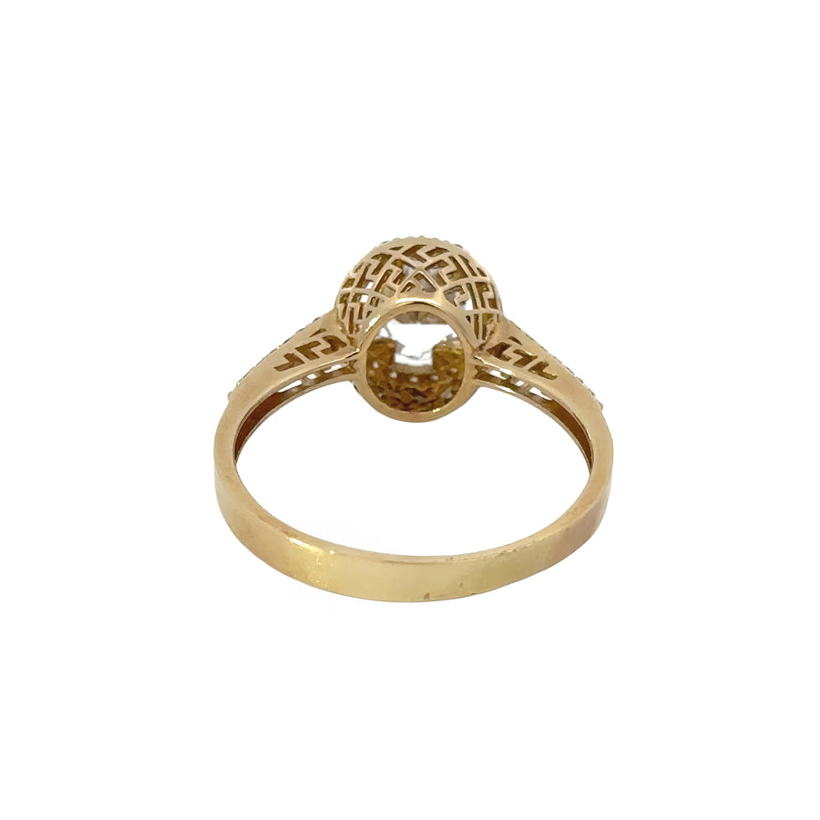 Woman wearing 14k gold ring with center CZ stone