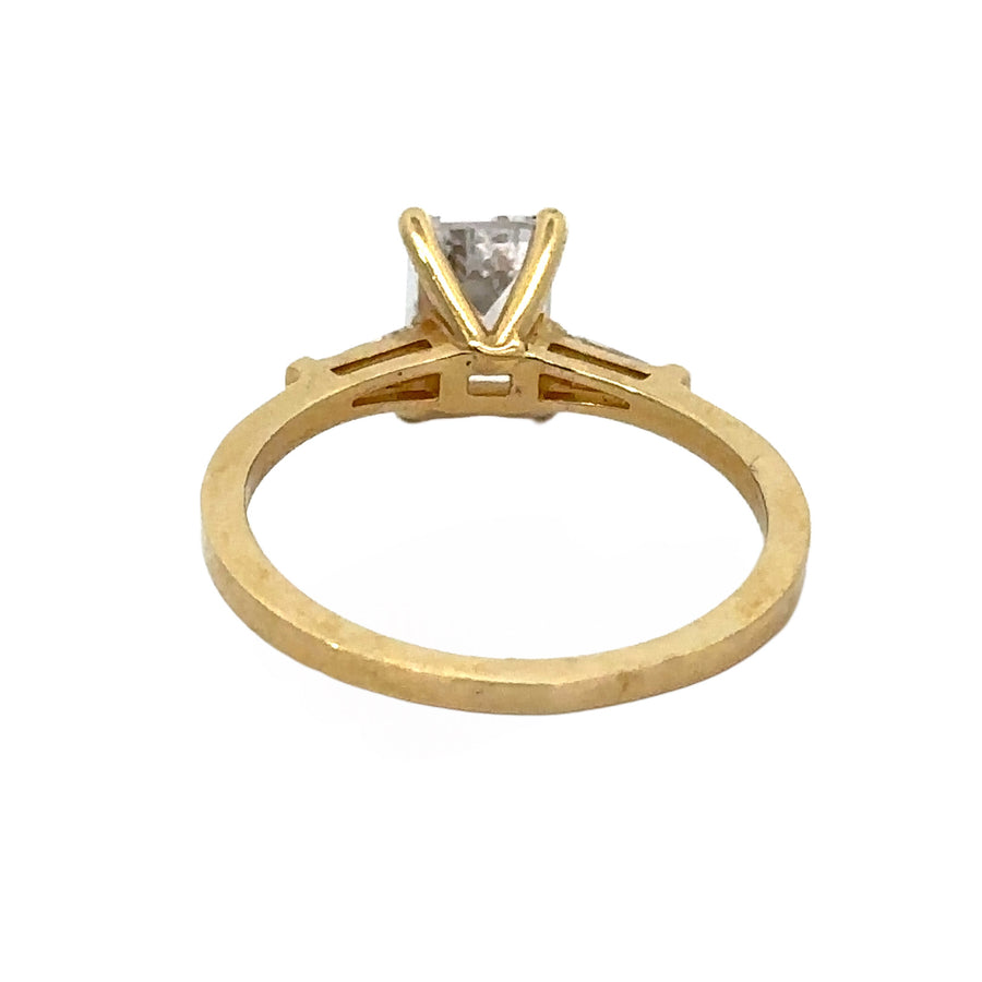 Woman wearing 14k gold center stone ring on finger