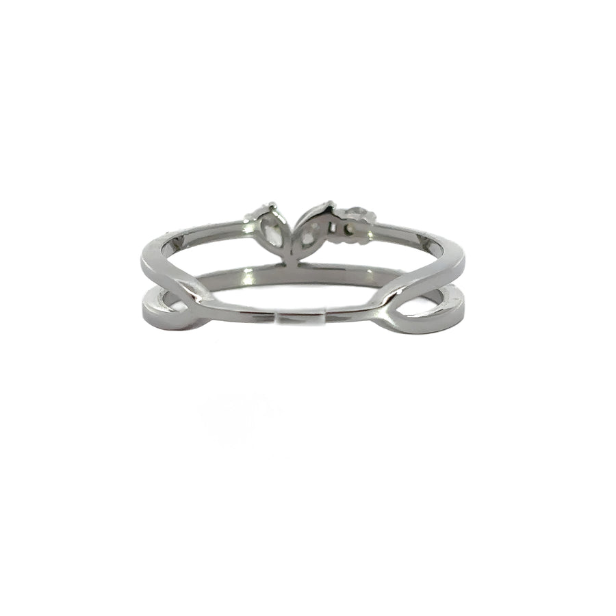 Woman’s hand wearing leaf-shaped gold ring with diamonds