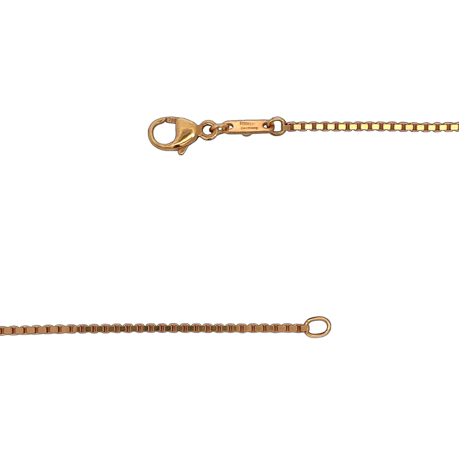Elegant gold chain with rose detail displayed flat