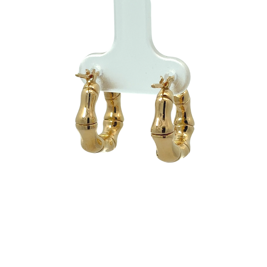 Woman wearing chic 14k gold small bamboo earrings