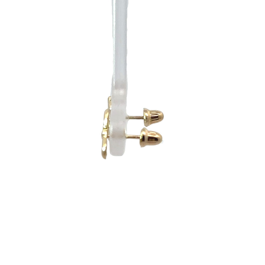 Baby wearing 14k gold small bow stud earrings