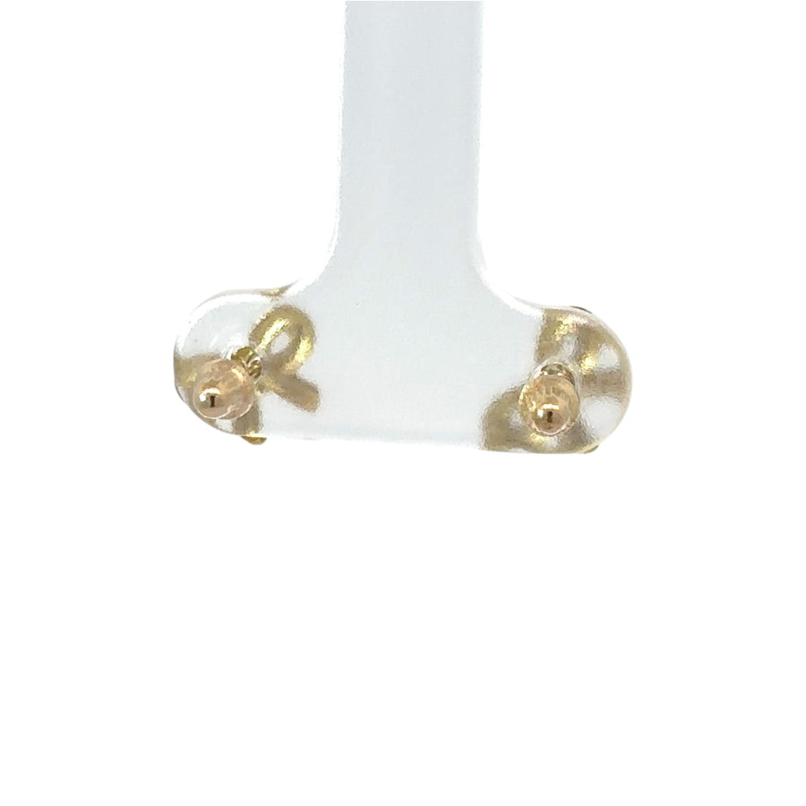 Polished 14k gold bow earrings displayed on white background