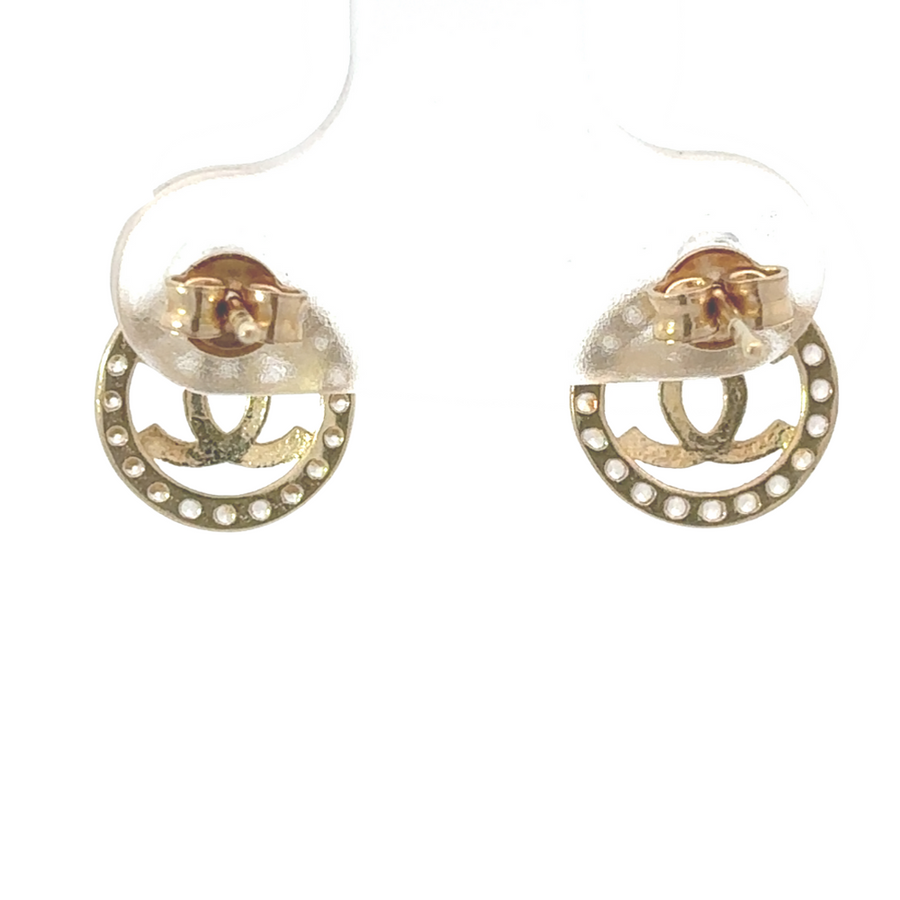 Woman wearing small gold circle earrings with CZ