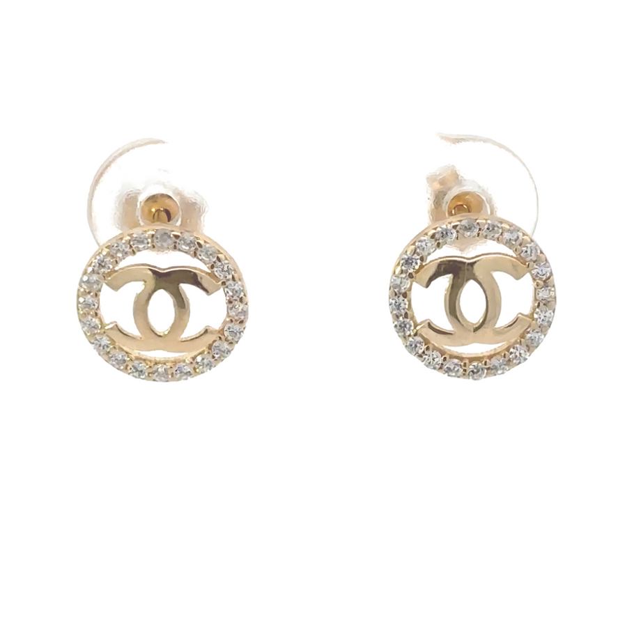 Pair of 14k gold small circle earrings with CZ on white background