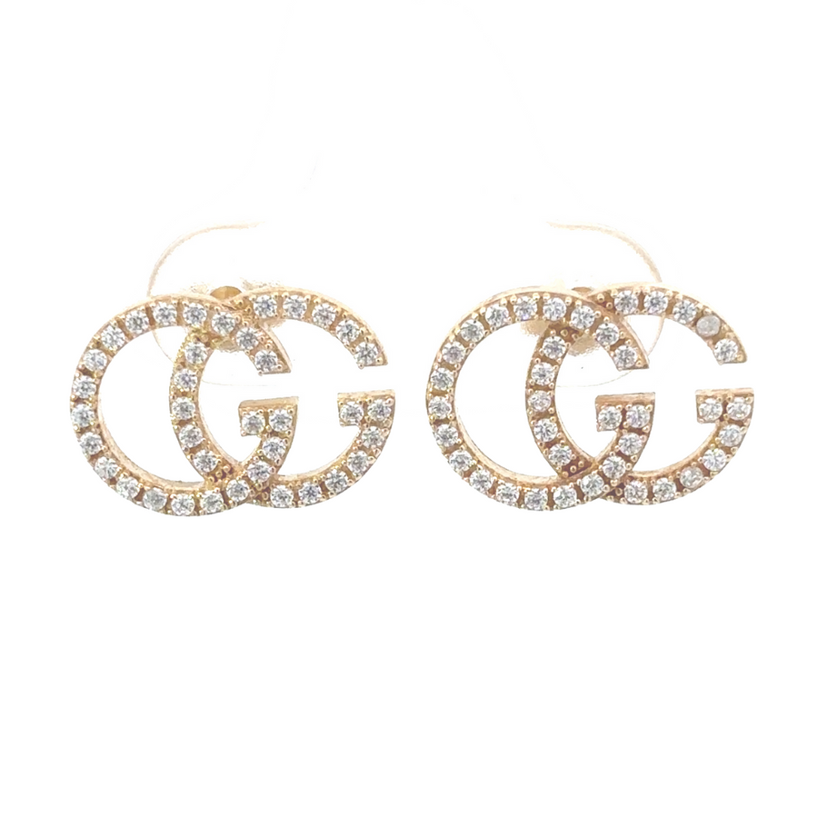 Pair of 14k gold CZ stud earrings displayed flat on a neutral fabric