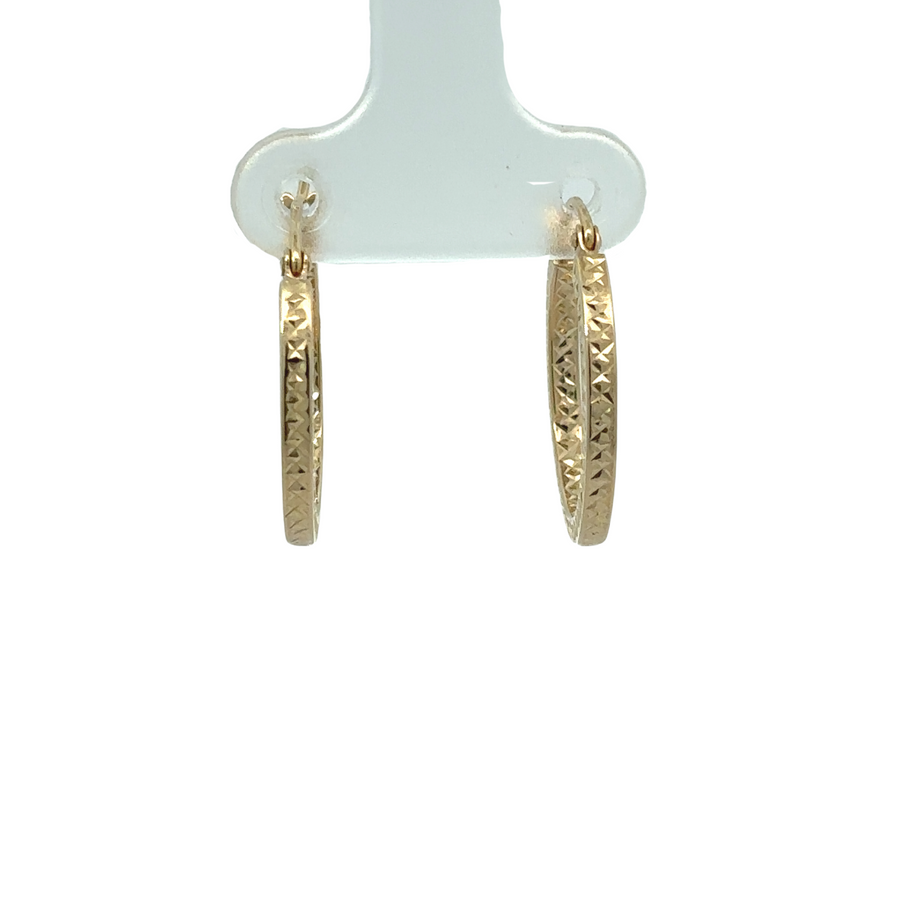 Close-up of 14k gold small faceted earrings