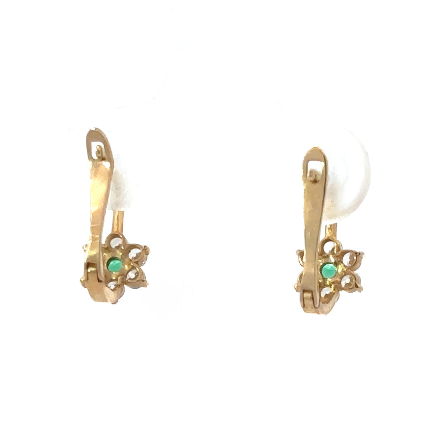Extra small gold flower earrings displayed in gift box