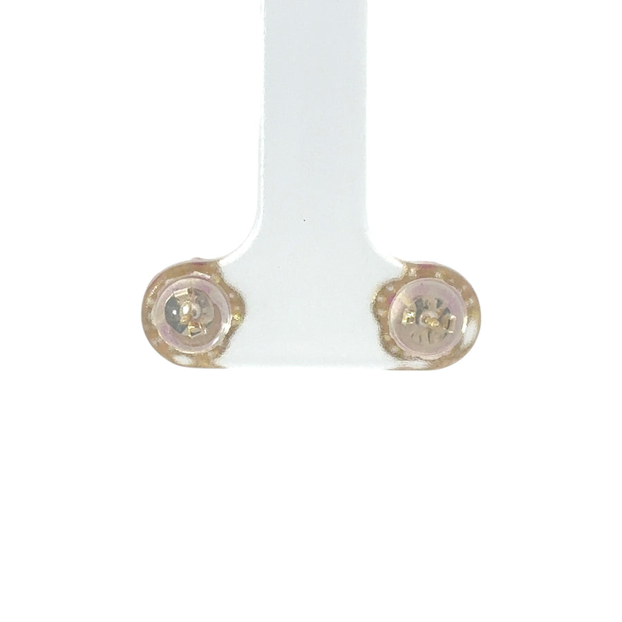 Close-up of flower-shaped stud with cubic zirconia center