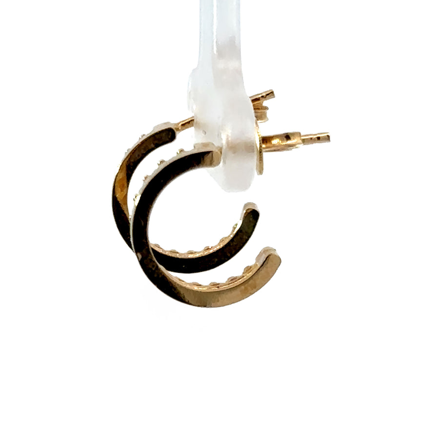 Close-up of 14k gold small hoop earrings with secure clasp