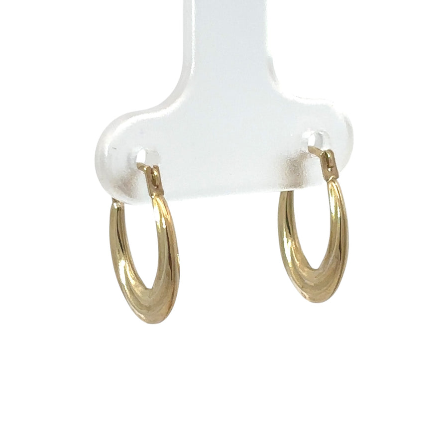 Close-up of 14k gold small oval line earrings for baby