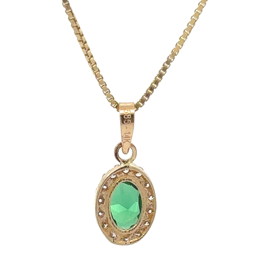 Model wearing small oval CZ pendant with a gold chain