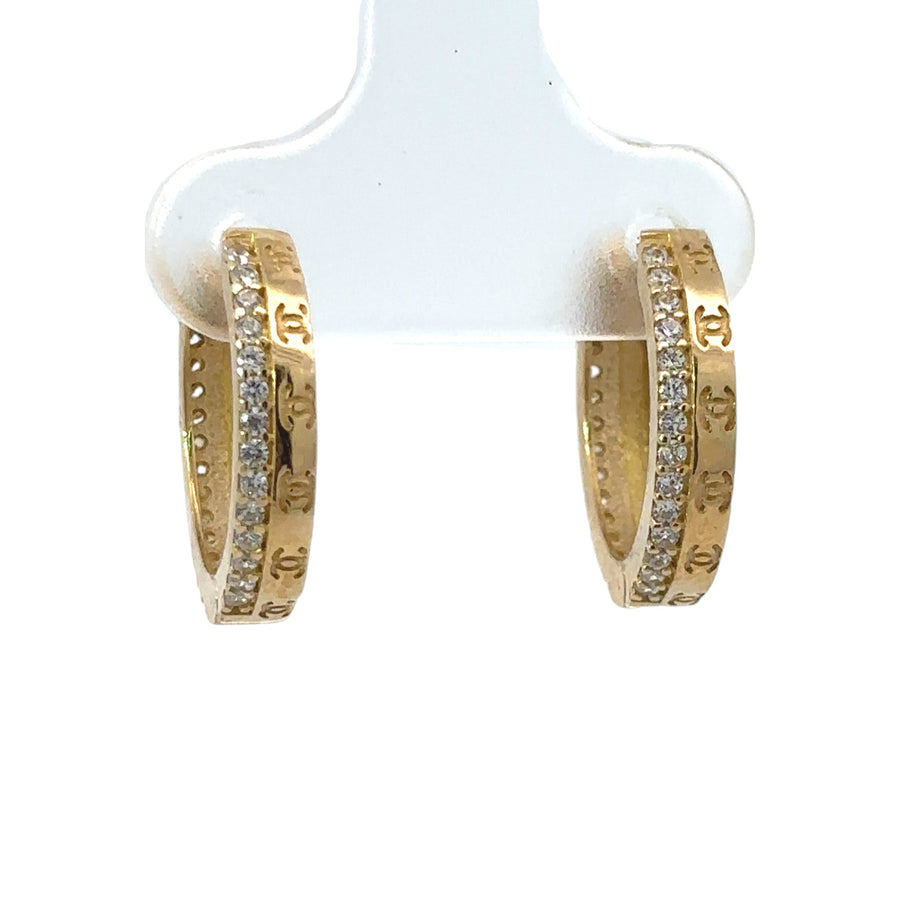 Close-up of polished 14k gold small earrings with smooth finish