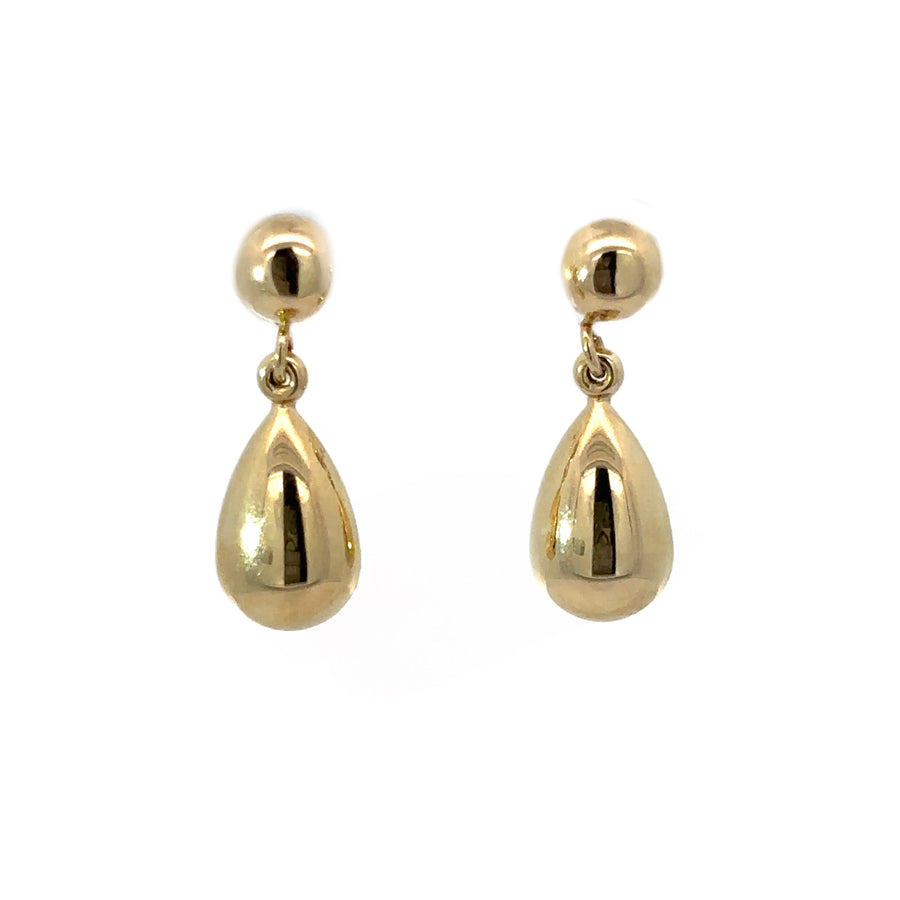 Close-up of sleek 14k gold drop earrings with minimalist design