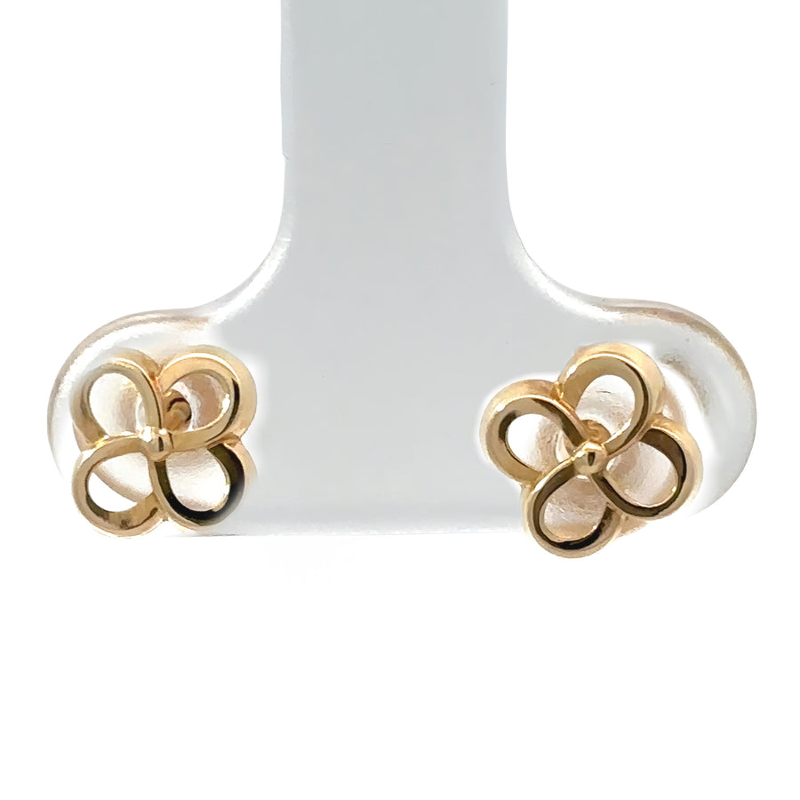 Close-up of 14k gold baby earrings with flower design