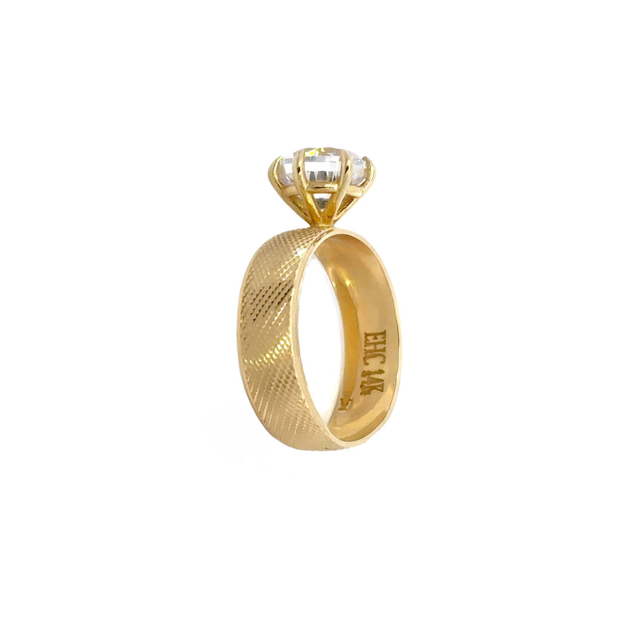 Minimalist 14k gold ring on a white background