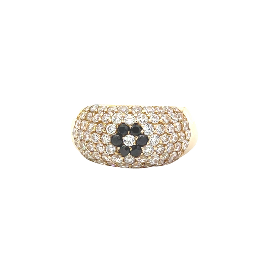 Close-up of 14k gold ring with CZ stone and flower design on white background