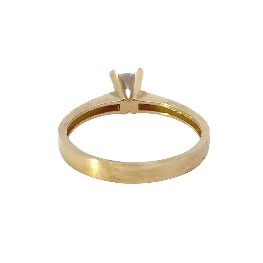 Close-up of solitaire gemstone set in 14k gold band