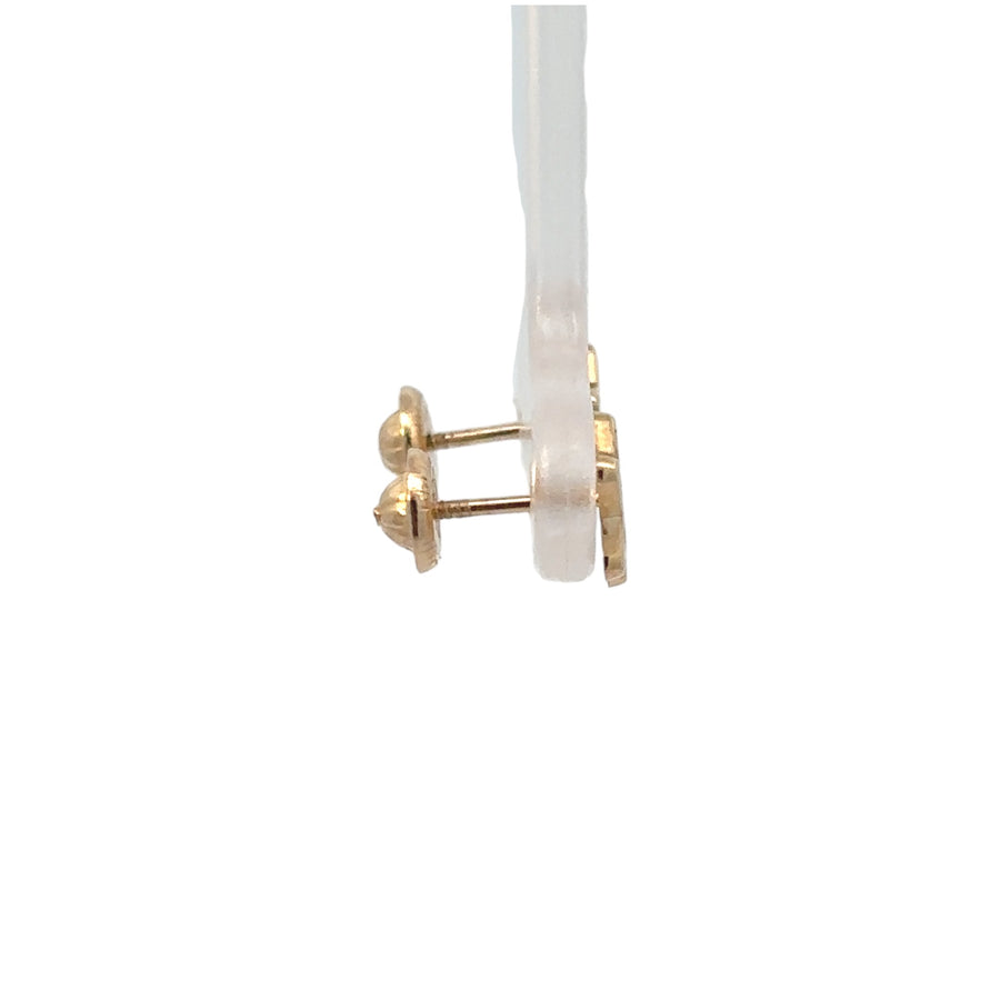 Pair of sparkling 14k gold star earrings on white background