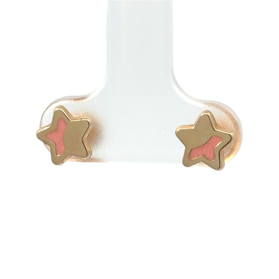 Close-up of delicate 14k gold star earrings
