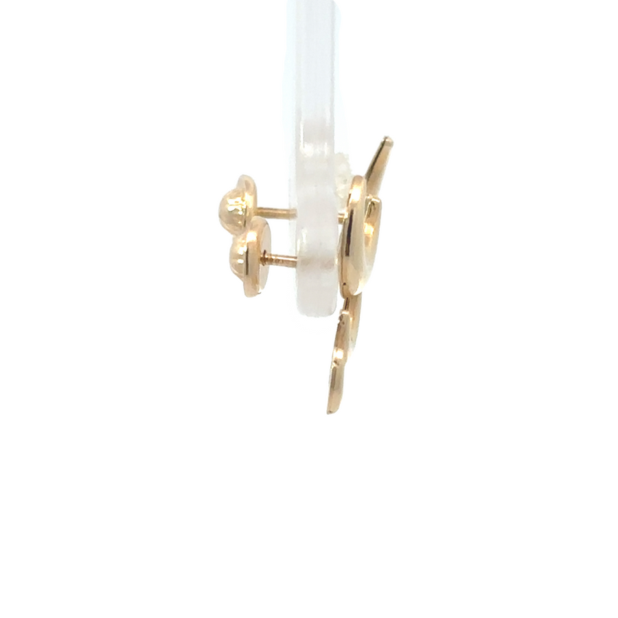 Close-up of celestial three-moon earrings in gold finish
