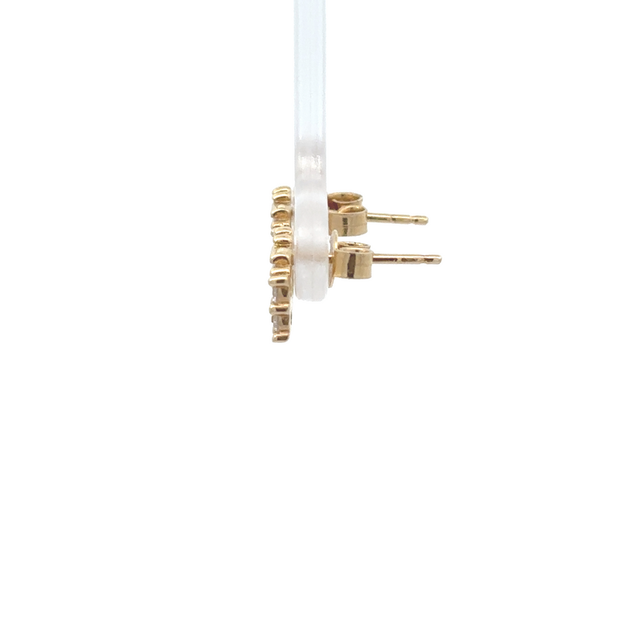 Close-up of gold stud earrings featuring brilliant cubic zirconia