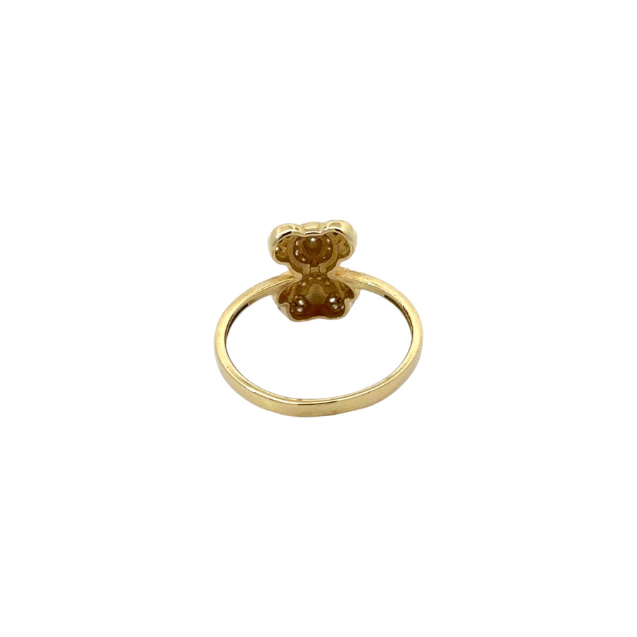 Close-up of teddy bear design with cubic zirconia on 14k gold ring