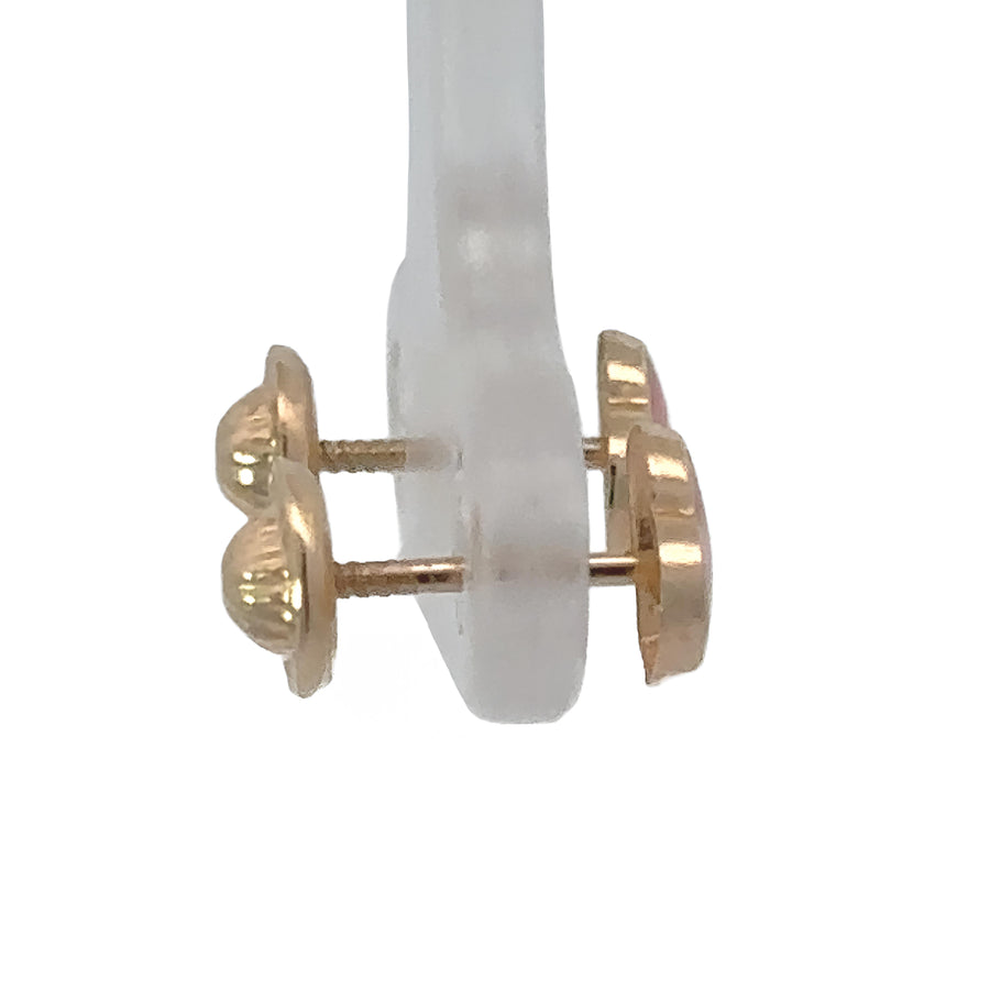 Side profile of small 14k gold heart studs showing smooth finish