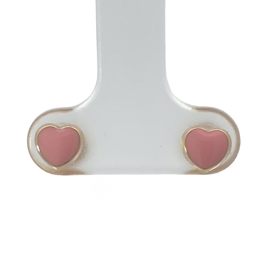 Close-up of 14k gold tiny heart stud earrings on white background