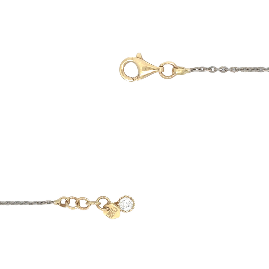 14k gold two-tone chain resting on a wooden surface, showcasing its elegant design