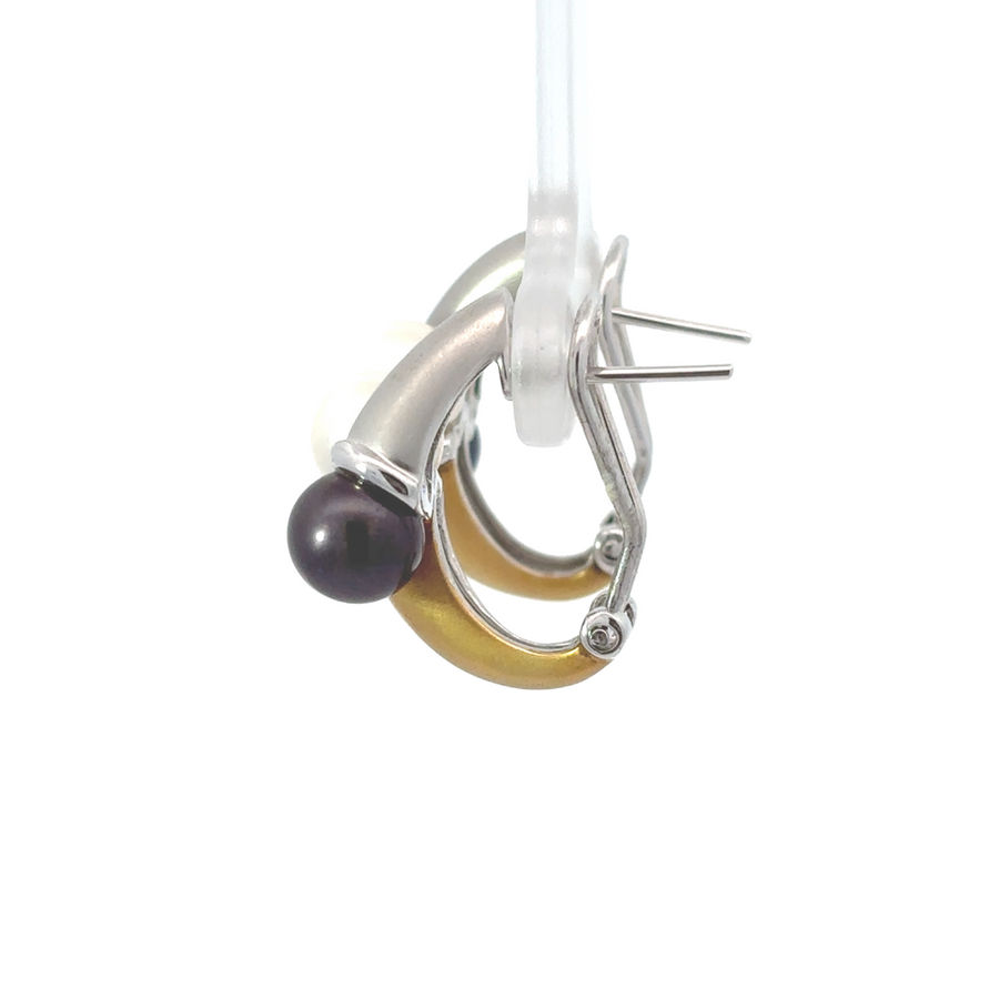 Elegant women's earrings featuring white and black pearls