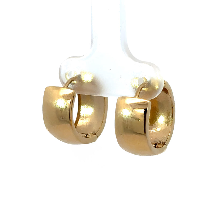 Pair of 14k gold huggies earrings featuring yellow and white gold tones