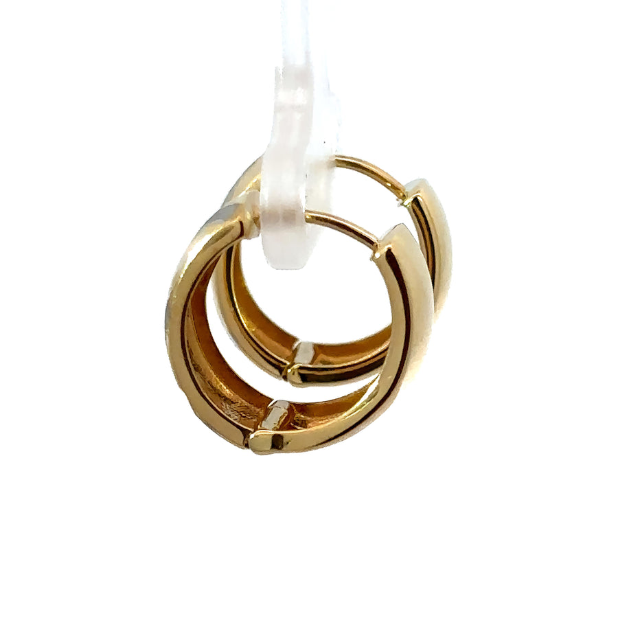 Woman wearing chic two-tone 14k gold line huggies earrings