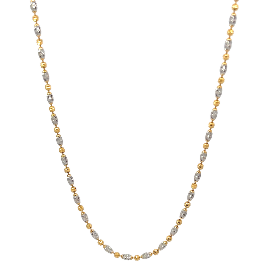 Close-up of the 14k gold two-tone necklace showcasing round and oval faceted links