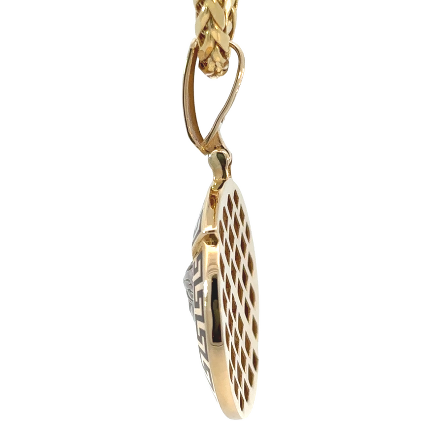 Side view of unisex 14k gold two-tone pendant with high-polish finish