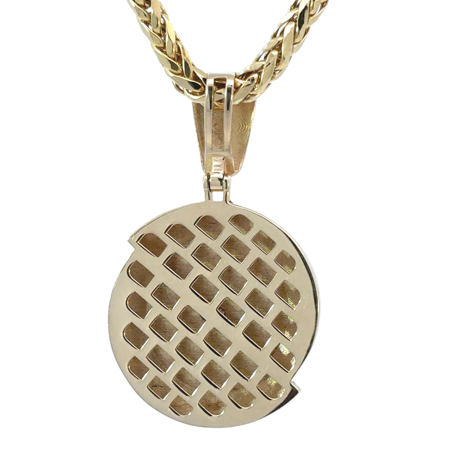 Detailed shot of 14k gold two-tone pendant with modern, sleek design