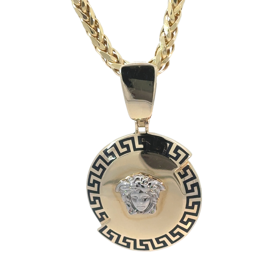 Elegant 14k gold two-tone pendant hanging on a chain against a dark background