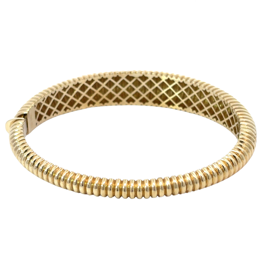 Elegant wide gold bangle styled for formal occasions