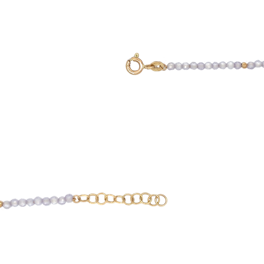 Adjustable gold bracelet with lila gemstones displayed in a gift box