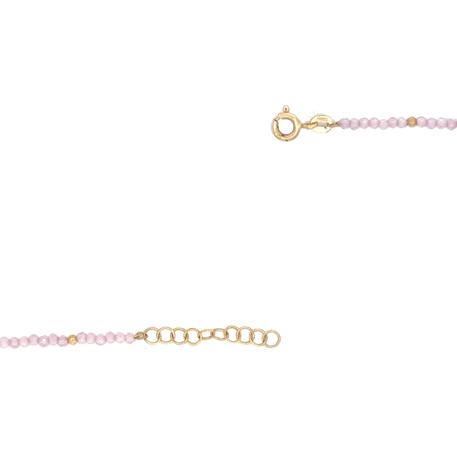 Feminine 14k gold bracelet with rose-colored stones, ideal for layering or wearing alone