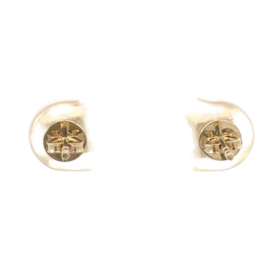 Gold earrings and necklace displayed together on a marble surface