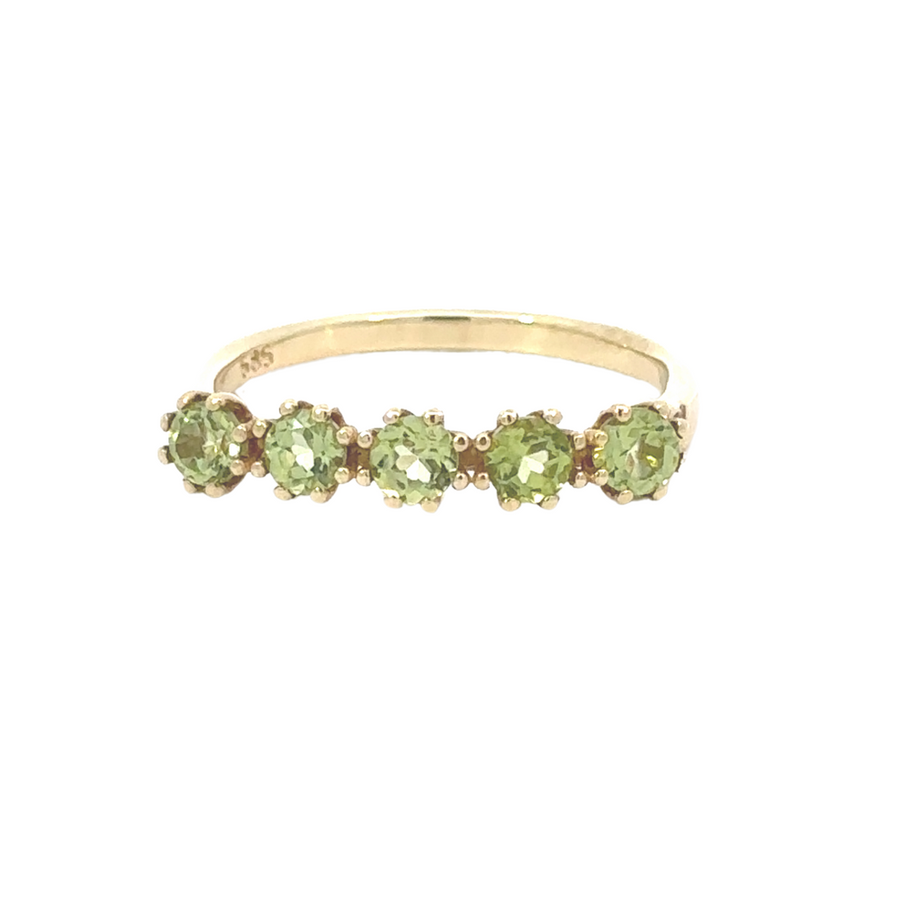 Side angle of 14k gold ring highlighting the green stones’ brilliance