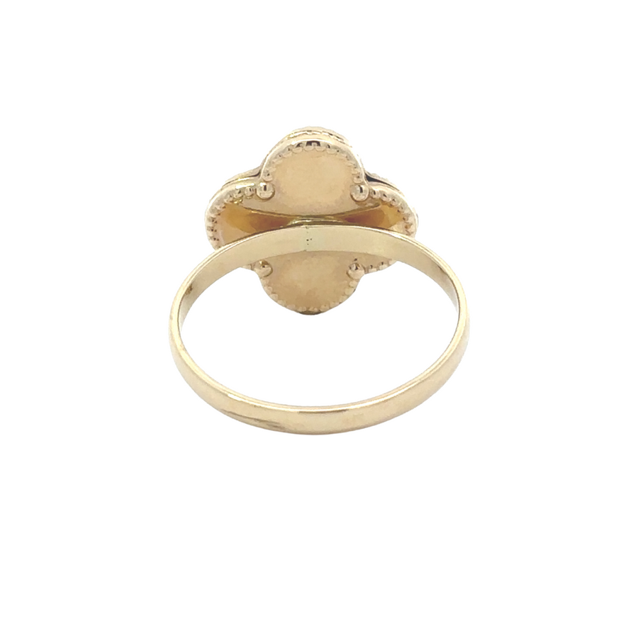 Detail of black gemstone set in 14k gold women's ring, minimalist and sophisticated