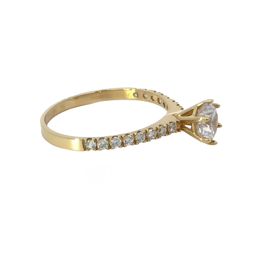 Woman’s hand wearing 14k gold solitaire ring with single gemstone
