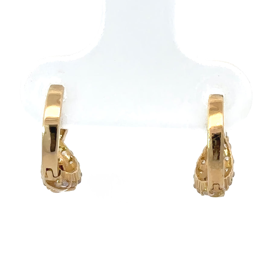 Tiny 14k gold earrings displayed in a jewelry box