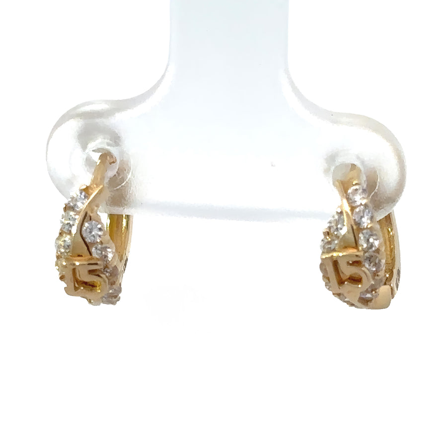 Close-up of XS gold baby earrings on white background